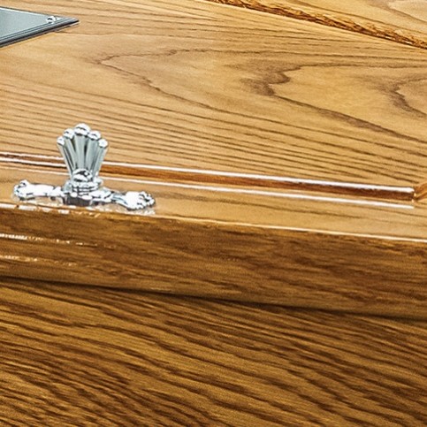 Chrome lid fitting and the beaded lid moulding of The Bolsover, showing the high gloss oak finish