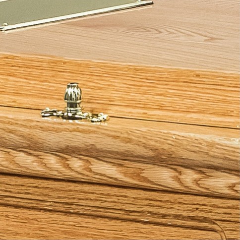 Brass lid fitting on the double raised lid of The Devonshire, showing the high gloss oak finish